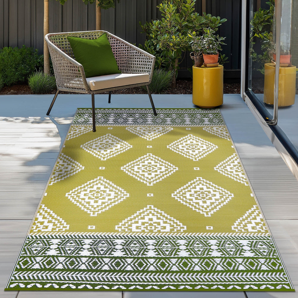 Venice Outdoor Rug in Golden Green, Deep Forest Green, and White – weather-resistant, eco-friendly, and ideal for patios or balconies. Featuring tribal diamond patterns, this lightweight rug adds vibrant charm to any outdoor space. Shop Green Decore UK