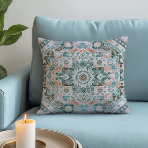 Green Decore Vernal Luke Beige, Green and Orange Indoor Cushion on a pastel blue sofa. Featuring a bold tribal motif, this cushion is perfect for boho décor, earthy interiors, stylish soft furnishings, and modern ethnic-inspired home décor accents.